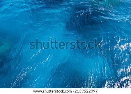 Seawater background. Blue sea with little waves texture. The unique color of the water. Seawater surface texture. Royalty-Free Stock Photo #2139522997