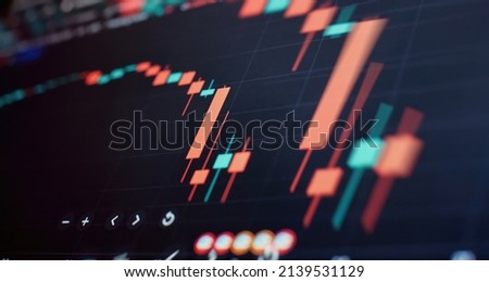 graph and indicator, red and green candlestick chart on blue theme screen, market volatility, up and down trend. Stock trading, crypto currency background. Royalty-Free Stock Photo #2139531129