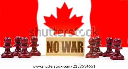 national concept. Against the background of the flag of Canada, pawns and a sign with the inscription - no war