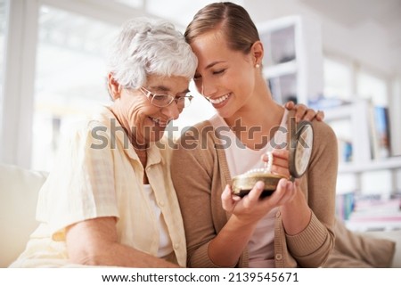 This is their family heirloom. Cropped shot of a senior woman giving her daughter a pearl necklace. Royalty-Free Stock Photo #2139545671