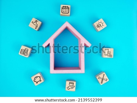Household expenses concept, cube wood with home expenses, Water bills, electricity bills, card bills, credit, phone bills, house repairs icons. flat lay.                                        Royalty-Free Stock Photo #2139552399