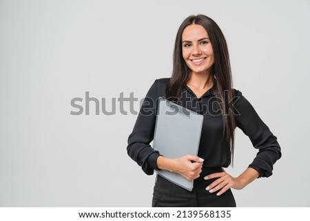 Female young businesswoman auditor inspector examiner controller in formal wear writing on clipboard, checking the quality of goods and service looking at camera isolated in white background Royalty-Free Stock Photo #2139568135