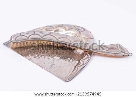 Awesome background image of abstract pastel made of vintage retro silver table cleaning brush and dustpan composition on white backdrop buying.