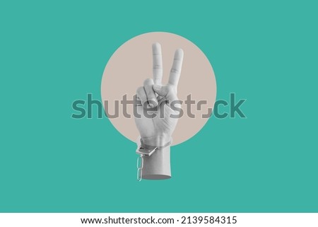 Digital collage modern art. Hand showing peace hand sign, with broken handcuff	