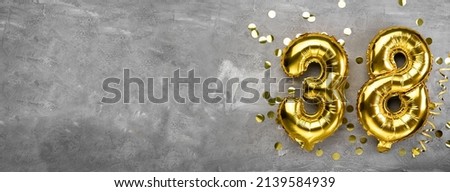 Yellow foil balloon number, number thirty eight on a concrete background. Greeting card with inscription 38. Anniversary concept. for anniversary, birthday, new year celebration. banner, copy space. Royalty-Free Stock Photo #2139584939