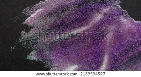 Closeup texture of abstract shining background. Glitter streaks and strokes of mixed colored lacquers on black textured paper. Bright shades of pink and purple. Panoramic image, banner cropping. Royalty-Free Stock Photo #2139594597