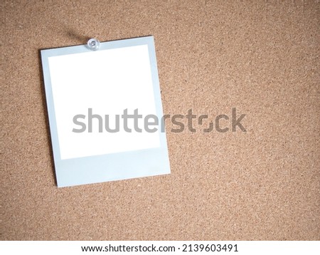 Blank white photo card template on cork board background for photo