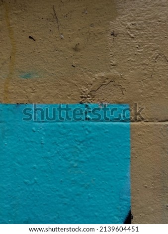 Detailed turquoise paint texture on a street wall 
