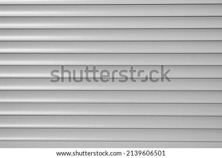 Roller blinds, gray horizontal metal roller shutters, close-up. Royalty-Free Stock Photo #2139606501