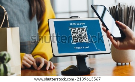 Customer using phone for payment at cafe restaurant, cashless QR code technology and money transfer concept Royalty-Free Stock Photo #2139613567
