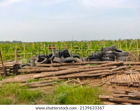 defocused abstract background car tires and wood piled on top of each other
