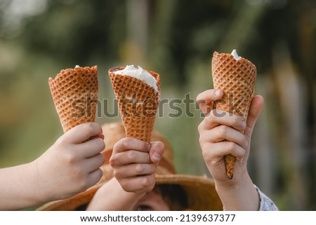 Children holding ice cream cone.
