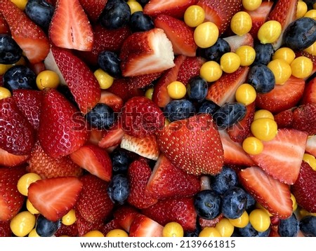 A closeup photo of a fruit salad containing strawberries, blueberries and gooseberries that looks very tastybackground, berries, berry, blue, blueberries, blueberry, breakfast, chopped, closeup, color