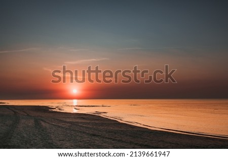 Clear sunset sky on sea shore with sandy beach