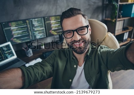 Self-portrait of attractive cheerful intellectual guy working remotely employment tech support at workplace station indoors.