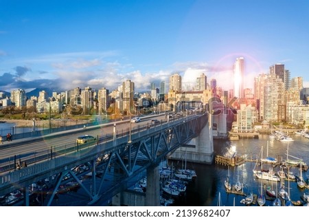 Beautiful view of downtown Vancouver skyline. Aerial photo of the vibrant city and bird view over the Burrard Bridge. British Columbia, Canada at sunset.