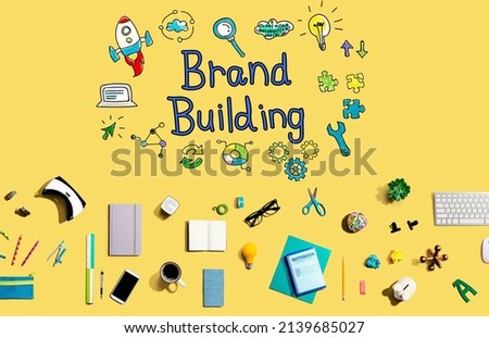Brand building with collection of electronic gadgets and office supplies