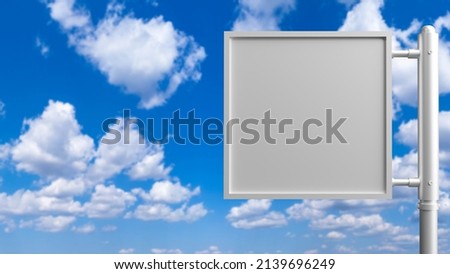 Square advertising banner on the background of the sky. A billboard and a blue sky with clouds. A place to advertise on a street banner. Advertising panel. 