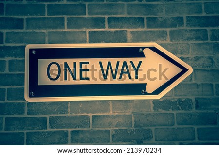 one way sign on brick wall - retro design direction message