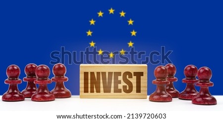national concept. Against the background of the flag of the European Union pawns and a sign with the inscription - invest