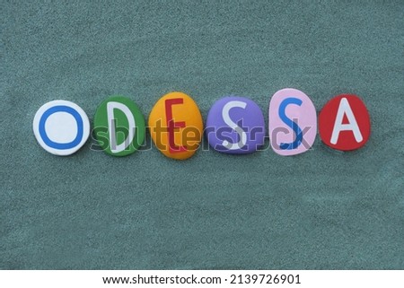 Odessa, city in Ukraine on the northwestern shore of the Black Sea. Souvenir composed with hand painted multi colored stone letters over green sand