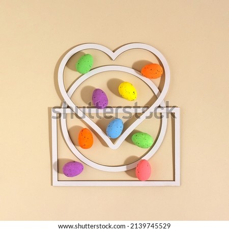 Easter eggs and geometric shapes of frames. Minimal concept on beige background. Flat lay.