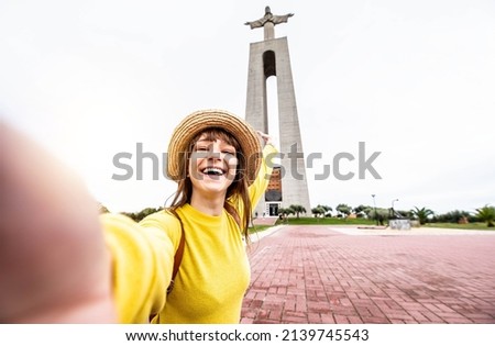 Happy tourist visiting Lisbon, Portugal - Beautiful young woman taking selfie while travel in European famous destination - Travel and vacations lifestyle concept