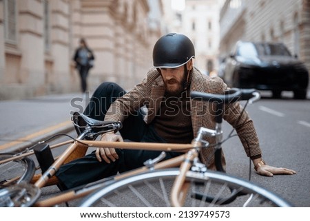 Bike injury, injured knee. Cyclist accident in city.  Royalty-Free Stock Photo #2139749573