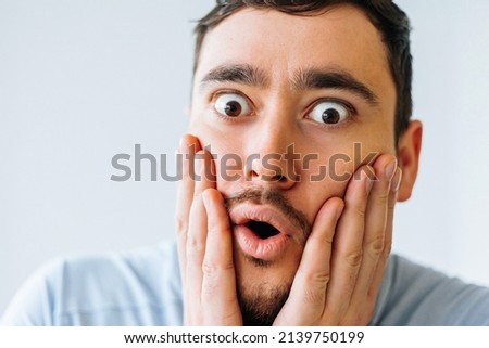 Beard man wonder, wearing casual t-shirt standing over isolated white background afraid and shocked with surprise expression, fear and excited face. Man looking at camera with surprised expression Royalty-Free Stock Photo #2139750199