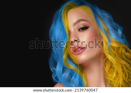 Beautiful woman with blue and yellow hair and classic make up and hairstyle. Beauty face.