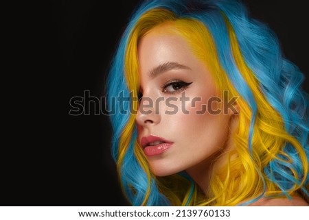 Beautiful woman with blue and yellow hair and classic make up and hairstyle. Beauty face.