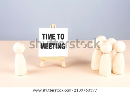 Time to Meeting text on a easel with wooden figure, meeting concept