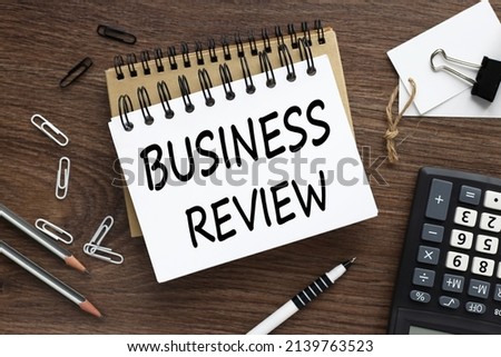 business review. two notebooks on the desktop text on the page