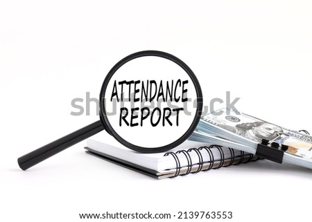 ATTENDANCE REPORT text on magnifier glass on white background on notepad