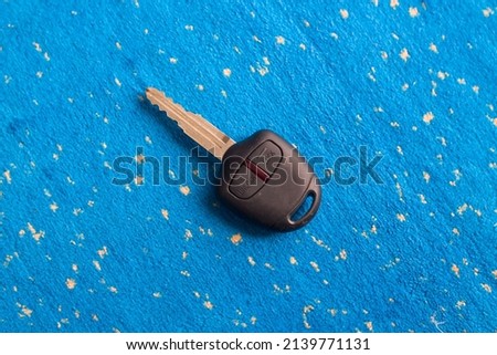 Car key isolated on blue background.