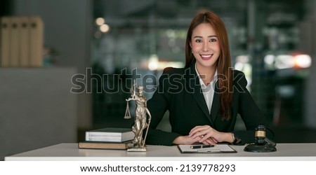 Portrait of young female Lawyer or attorney working in the office, smiling and looking at camera. Royalty-Free Stock Photo #2139778293