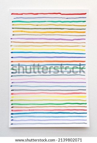 Abstract watercolor lines pattern background. Colorful watercolor painted brush strokes on white paper. Close-up.