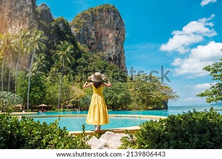 Woman tourist in yellow dress and hat traveling on Railay beach, Krabi, Thailand. vacation, travel, summer, Wanderlust and holiday concept Royalty-Free Stock Photo #2139806443