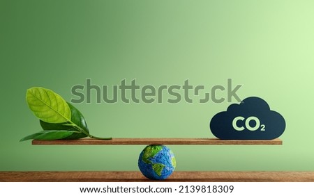 Carbon Neutral and ESG Concepts. Carbon Emission, Clean Energy. Globe Balancing between a Green leaf and CO2. Sustainable Resources, Big deal for Company and Indstry to Concern about Environmental Royalty-Free Stock Photo #2139818309