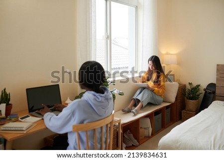 Serious female college students studying in dormitory Royalty-Free Stock Photo #2139834631