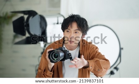 Male photographer taking a picture with a camera