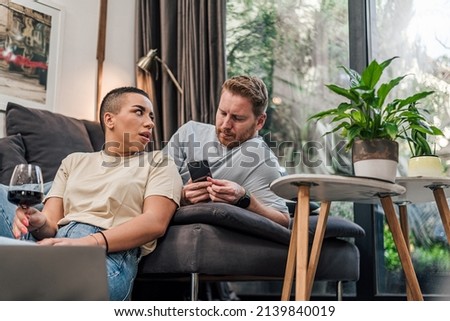 Stunned short haired woman, listening to her worried husband. Royalty-Free Stock Photo #2139840019