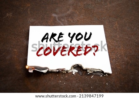 Are You Covered. Burning sheet of paper with text.