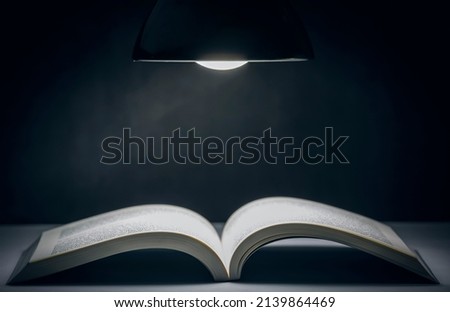 Lamp with book notes style vintage dark background, The idea of reading books, knowledge, and searching for new ideas, book bible.Concept Royalty-Free Stock Photo #2139864469