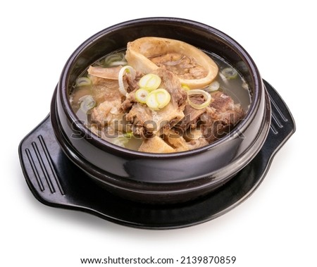 Beef bone marrow soup in hot iron pot isolated on white background, Beef Stock Bone soup or Seolleongtang in iron pot on white With clipping path.