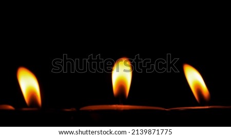 Candle flame on a black background religious ceremony