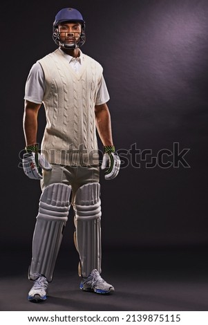Ready to hit the pitch. A cropped shot of an ethnic young man in cricket attire isolated on black.