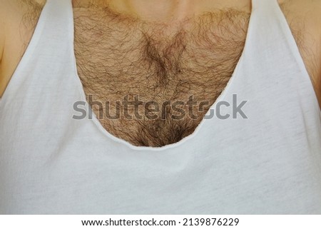 male hairy chest under white stretched tank top