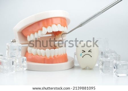 Tooth decay sensitive is crying with cold ice on white background ,Dental concept of tooth sensitivity from drinking cold water Royalty-Free Stock Photo #2139881095
