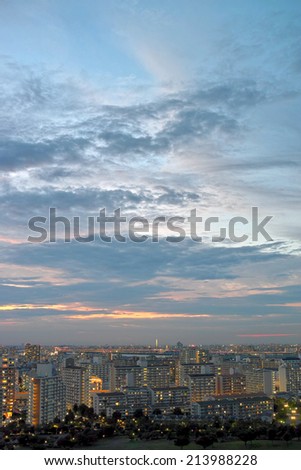 Tokyo skyline under sunset sky with flowing clouds